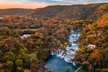 Krka, Croatia - Aerial panoramic view of the famous Krka Waterfalls in Krka National Park on a bright autumn morning with amazing colorful autumn foliage and sunrise