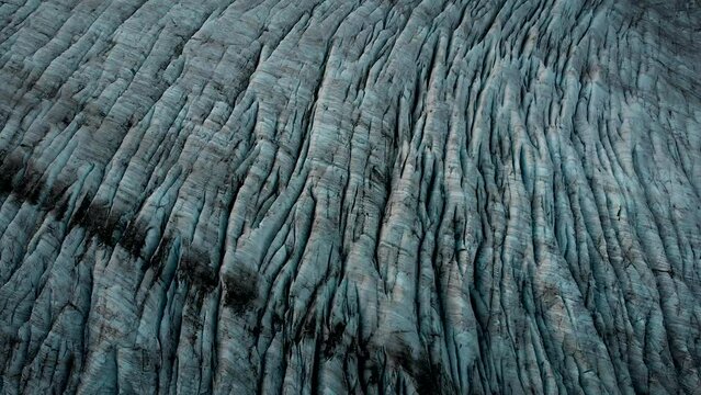 Aerial view of the Gauli glacier in the Bernese Oberland region of the Swiss Alps with a panning overhead view over the ice and crevasses.