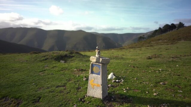 Camino de Santiago yellow arrow shell sign showing way to Compostela