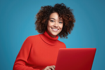 Woman wearing red turtle neck sweater using red laptop. This image can be used to illustrate technology, working from home, or online communication.