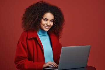 Woman with curly hair using laptop. Suitable for technology and business concepts.