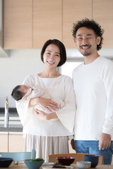 Happy portrait in front of the kitchen, looking at the camera