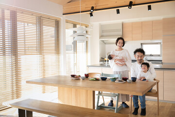 Happy smiling family Wide angle eating at the table of a beautiful house with text space on the...