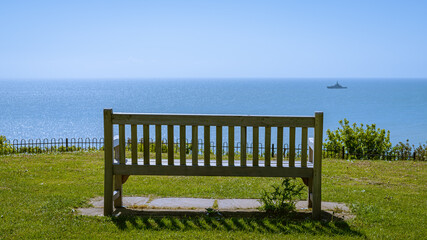 Fototapeta na wymiar Bench overlooking the Channel at the Lower Leas Coastal Park in Folkestone, Kent, England