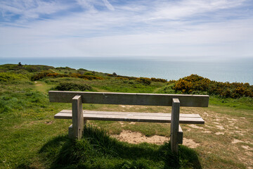 A bench overlooking the British Channel coast in Hastings County Park, East Sussex, England, UK