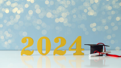 Class of 2024 concept. Wooden number 2024 with a graduate hat on a blue background with bokeh.Congratulatory banner.Freedom and Happy New Year. success in the future goal and passing time.