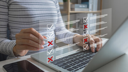 Woman using laptop doing online checklist survey, Document management system DMS, performance...