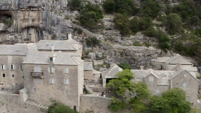 Blaca Hermitage - Ancient Settlement Hidden On Rock Mountains, Brac island, Croatia. Aerial Sideways Shot