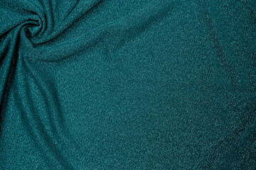 Trendy 80s, 90s, 2000s Background of draped dark green fabric with silver lurex thread. Beautiful...