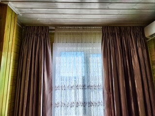 Beautiful curtains on the window with tulle, thick curtains and the sky in the background. Abstract...
