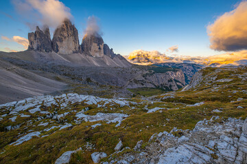Dolomites' beauty revealed, Tre Cime di Lavaredo adorned in the warm glow of an autumn sunrise. A captivating snapshot of nature's serene elegance in Italy
