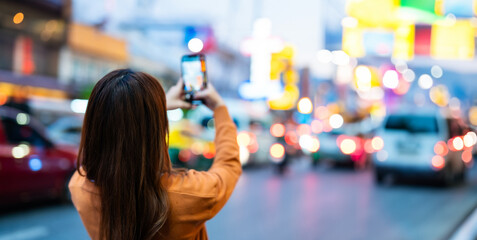 Young Asian tourists standing selfie taking a photo. Young woman beautiful tourists in Chinatown...