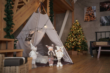 Teepee tent in the nursery room at christmas holidays with christmas tree