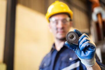 Senior professional electrical or industrial engineer inspecting and repairing a robotic system in the manufacturing factory close up. Robotic technician repairing - fixing a automated machine.