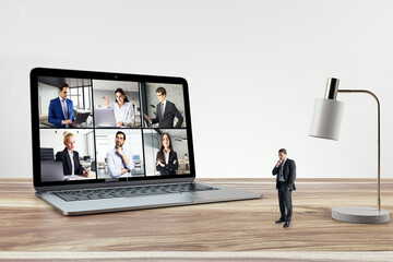Business professional on a video call with multiple colleagues on a laptop. Remote collaboration
