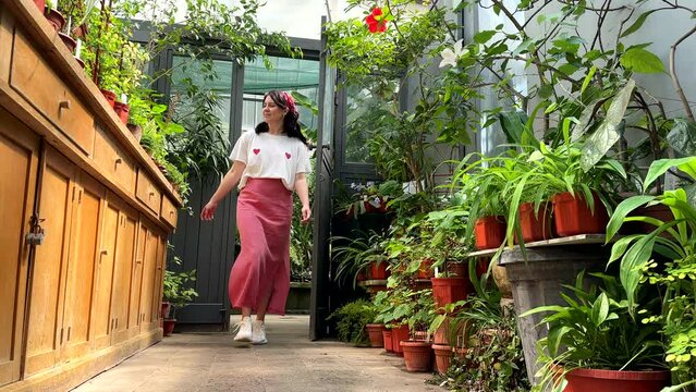 beautiful woman walking by botanic garden