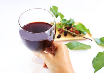 Mulberry juice in glasses , laying on branches and ripe fruits, crimson red contrasting with green, is a fruit that is high in vitamin C. on a white background

