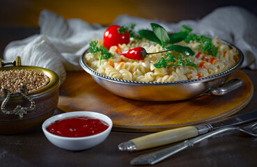 Pasta, spaghetti in a plate with seasonings and vegetables. Hot, natural and tasty dish.