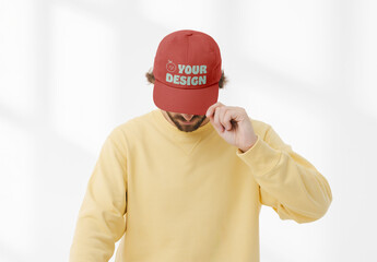 Mockup of man wearing customizable cap pulling peak down