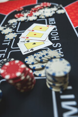 The winning combination is four aces cards and chips on casino table