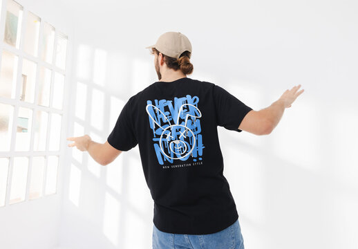 Mockup of man with wearing customizable t-shirt and cap dancing