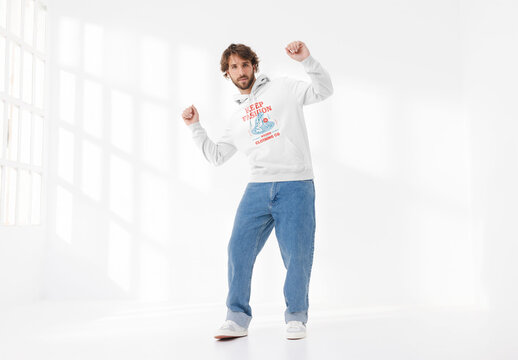 Mockup of man wearing customizable hoodie dancing in studio