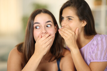 Gossip woman telling secret to the ear to a friend