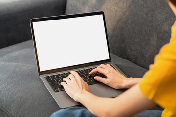 Woman hand type on the keyboard on laptop with mockup of blank screen for the application.