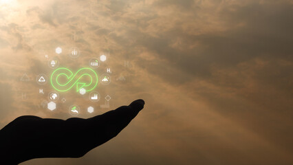Environmental concept. Circular economy symbol on Hands holding virtual infinity with technology ....