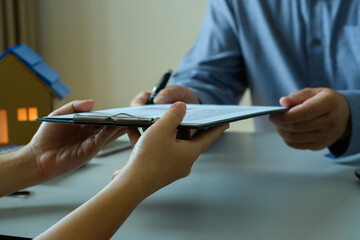 Accountant's hand receiving business documents and Signing  business contract Signing to approve...