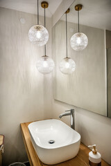Modern Bathroom. Stylish sink is perched atop wooden shelves. The focal point is accentuated by the...