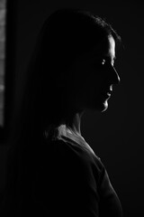 silhouette of a woman. Light and shadow. single woman. beautiful lady in dark. womens day. elegant 