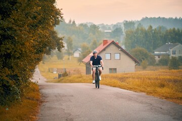 Obraz premium Man rides a bicycle. Exploring nature. Into the Wilderness. Cycling Adventure in the Forest