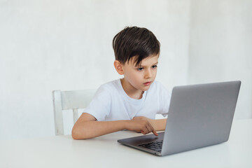 homeschooling student education lessons boy schoolboy learns at the computer online school in the classroom