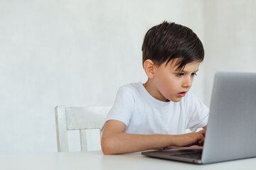 homeschooling student education lessons boy schoolboy learns at the computer online school in the classroom