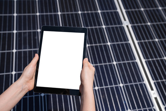 Hands with digital tablet on a background of solar panels