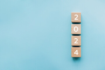 2024 New Year start concept. Wooden blocks with number 2024 on blue background