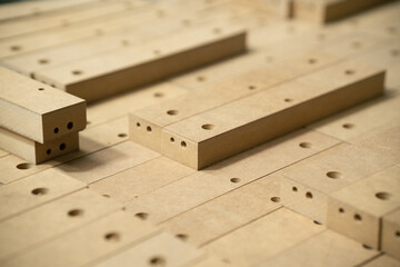 Close up of wooden parts in in big furniture manufacturing facility. Wooden parts for the...