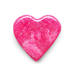 Pink shimmering nail polish in heart shape composition texture isolated on white background. Cosmetic makeup product
