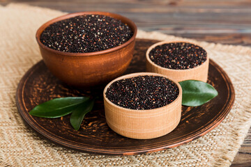 quinoa seeds in bowl on colored background. Healthy kinwa in small bowl. Healthy superfood
