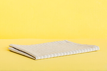 top view with gray kitchen napkin isolated on table background. Folded cloth for mockup with copy space, Flat lay. Minimal style