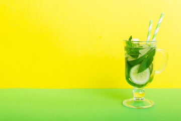 Mojito summer refreshing cocktail with ice and mint. mojito cocktail with lime, lemon and mint in a tall glass with a stick