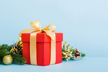 New Year Christmas mood, gift box, branches of a christmas tree, New Year decorations on a colored background