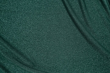 Trendy 80s, 90s, 2000s Background of draped dark green fabric with silver lurex thread. Beautiful...