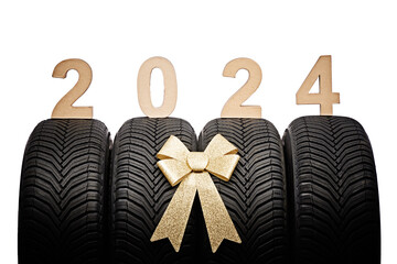 Car tires, new year 2024 tyres, winter wheels golden christmas ribbon