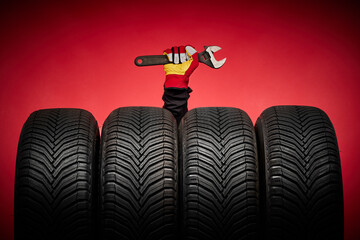 Car tires service and hand with wrench of mechanic man on red background, safety racing and good...