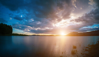 Fototapeta na wymiar Tranquil mountain landscape with calm lake and dramatic sky