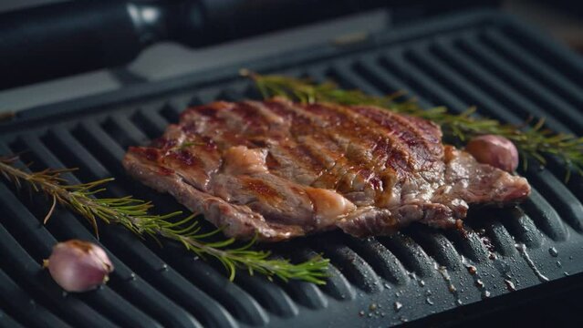 Hot delicious beefsteak on electic grill. 4k video footage