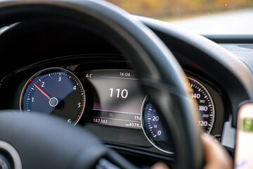 Steering wheel in a car close up, high speed driving on the road.