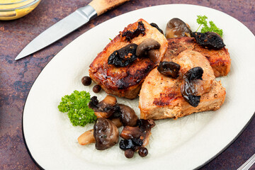 Baked pork medallions with mushrooms.